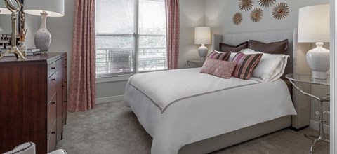 a bedroom with a bed and a dresser and a window