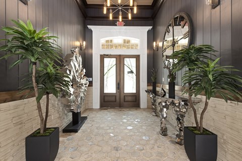 A hallway with a white door and a mirror on the wall.