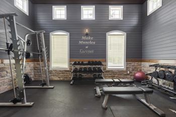 A gym room with a sign that says "Jake Miller's Fitness".