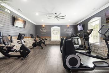 A gym with treadmills and elliptical machines.