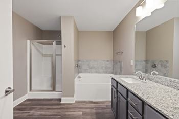 A bathroom with a white tub and sink.