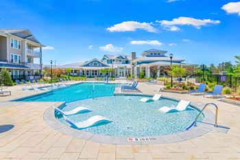 Resort-style swimming pool with in-water lounge chairs at The Highland in Augusta, GA