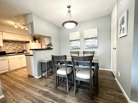 an empty dining room with a table and chairs
