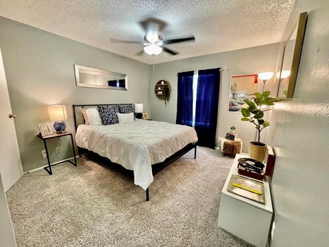 a bedroom with a bed and a ceiling fan