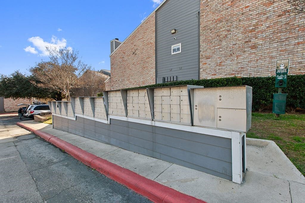 a retaining wall in front of a brick building