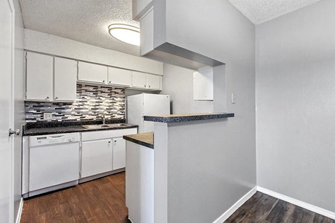 a kitchen with white cabinets and a counter top