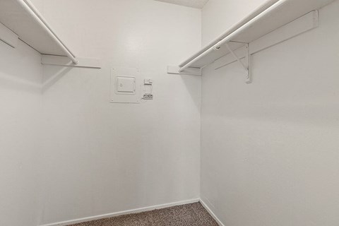 an empty room with a white wall and a white closet
