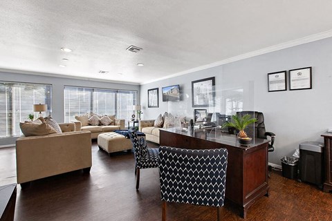 a living room with a desk and a couch