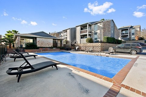 a swimming pool in front of an apartment building
