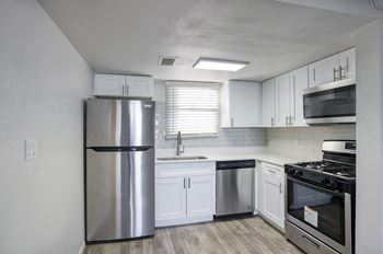 kitchen with stainless steel appliances and white cabinets at Mark at 87 Apartments, Mesa
