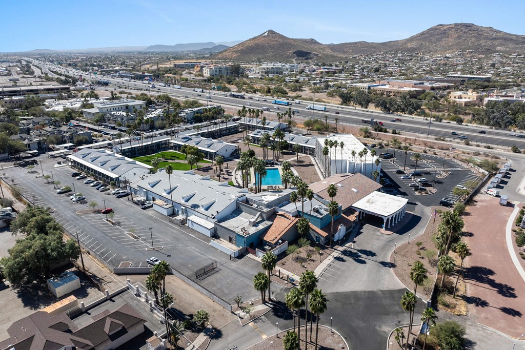 A large building complex with a parking lot in front of it at Presidio Palms Apartments, Tucson, 85701