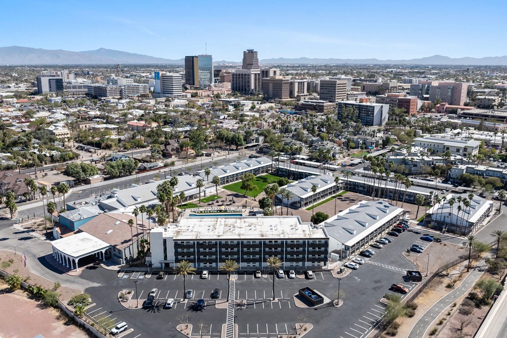 A large building with a parking lot in front of it at Presidio Palms Apartments, Tucson, Arizona