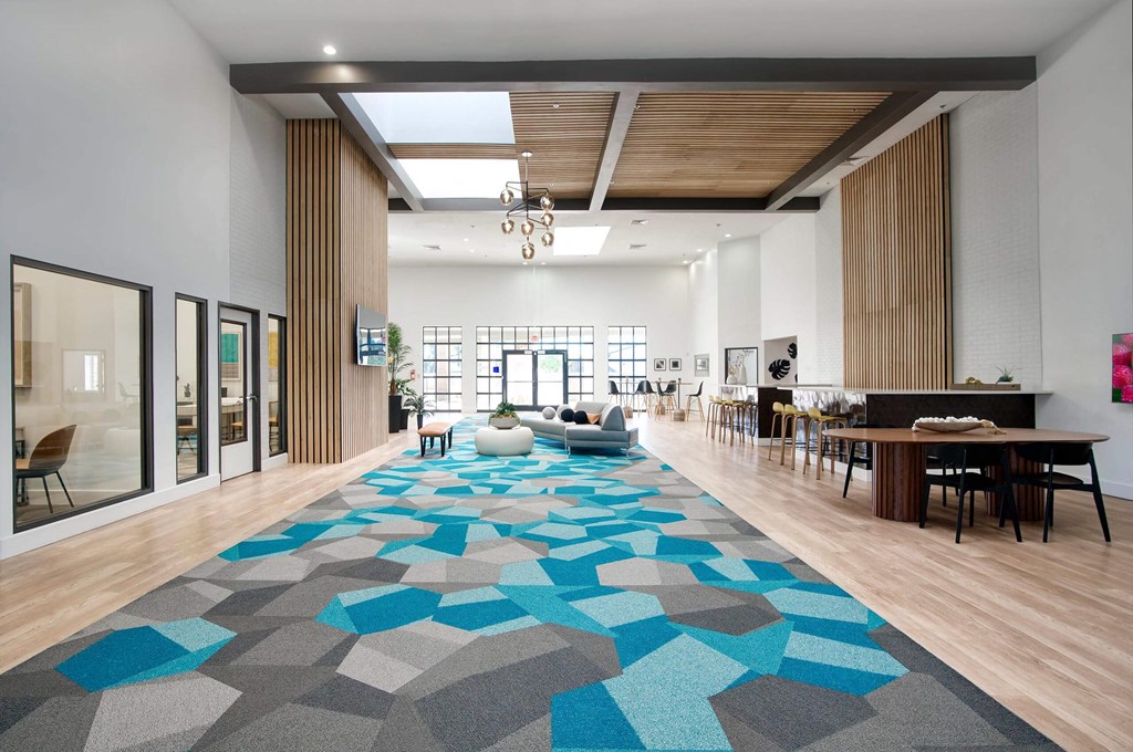 a large lobby area with a geometric rug at Presidio Palms Apartments, Tucson, Arizona