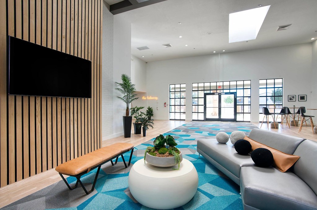 a clubhouse room with couches and a coffee table at Presidio Palms Apartments, Tucson, AZ