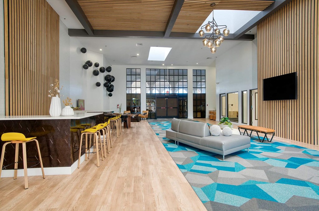 Lobby area with a couch and television at Presidio Palms Apartments, Arizona , 85701