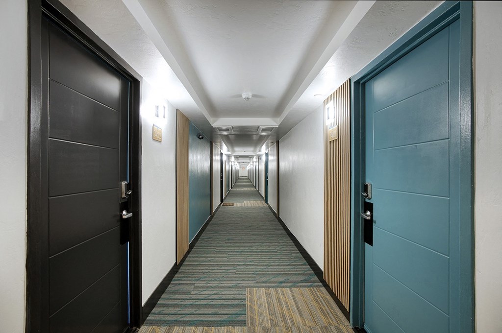A long hallway with colorful features at Presidio Palms Apartments, Tucson