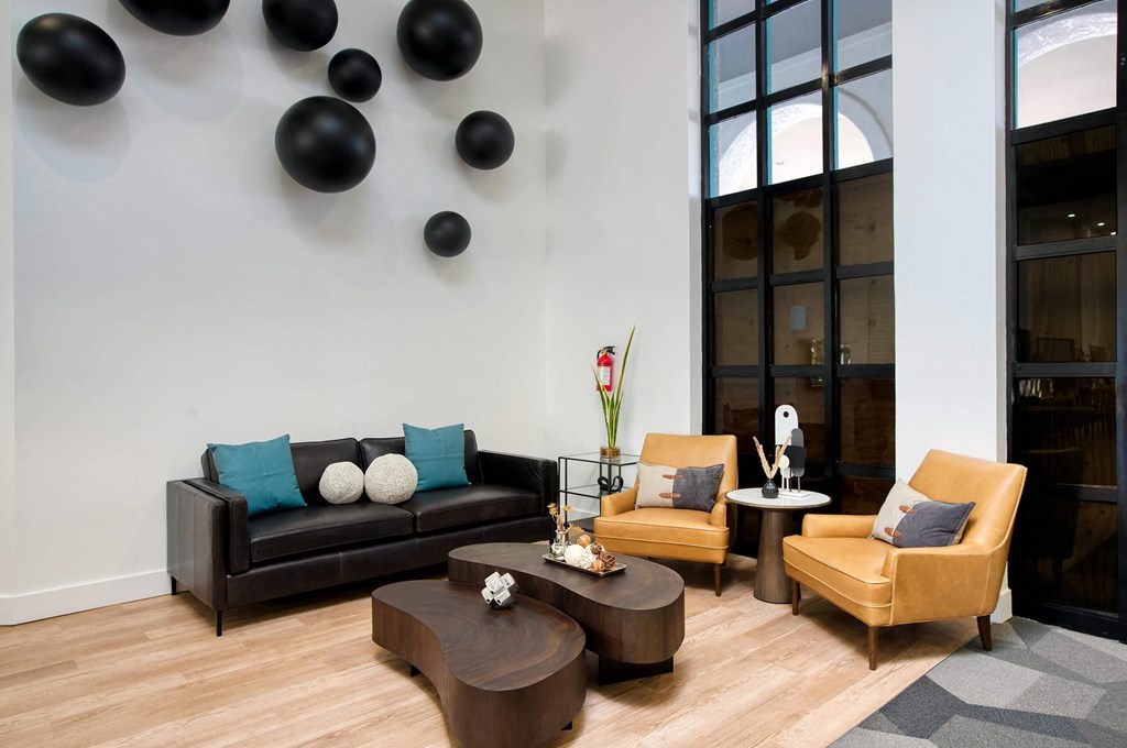 a resident lounge with couches chairs and a table at Presidio Palms Apartments, Tucson, AZ