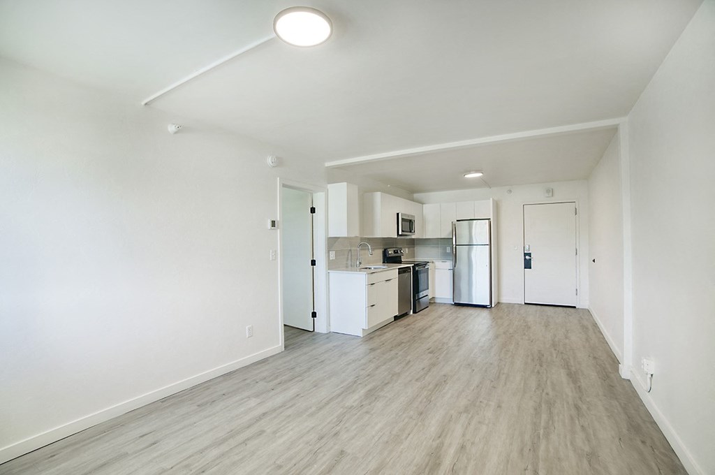 A kitchen area with a refrigerator, sink, and ovenat Presidio Palms Apartments, Tucson, AZ