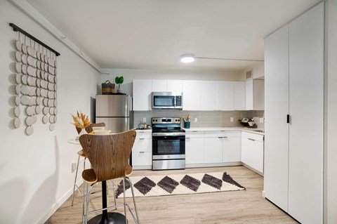 a kitchen with white cabinets and stainless steel appliances at Presidio Palms Apartments, Tucson, AZ, 85701