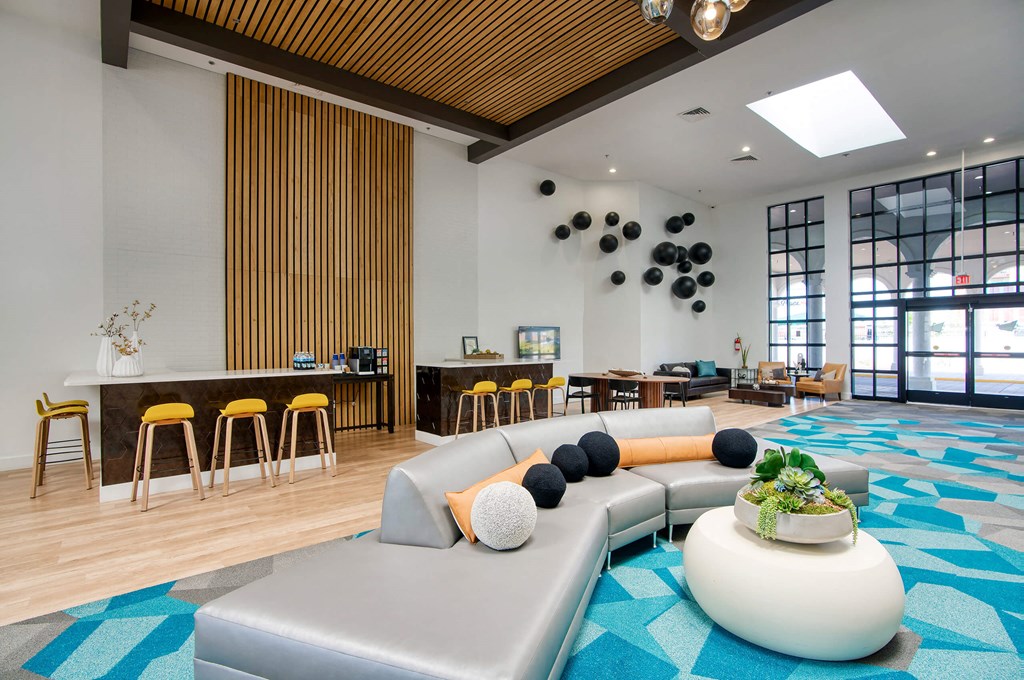 the lobby of a hotel with a large couch and tables at Presidio Palms Apartments, Arizona, 85701