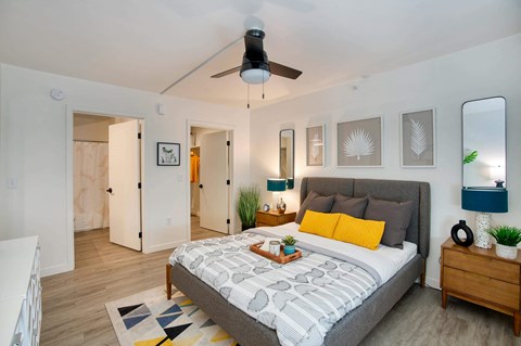 a bedroom with a bed and a ceiling fan at Presidio Palms Apartments, Tucson