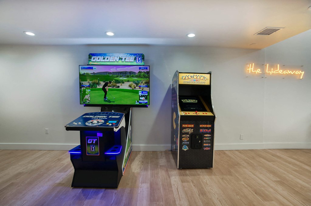 a living room with two video games and a tv at Presidio Palms Apartments, Tucson