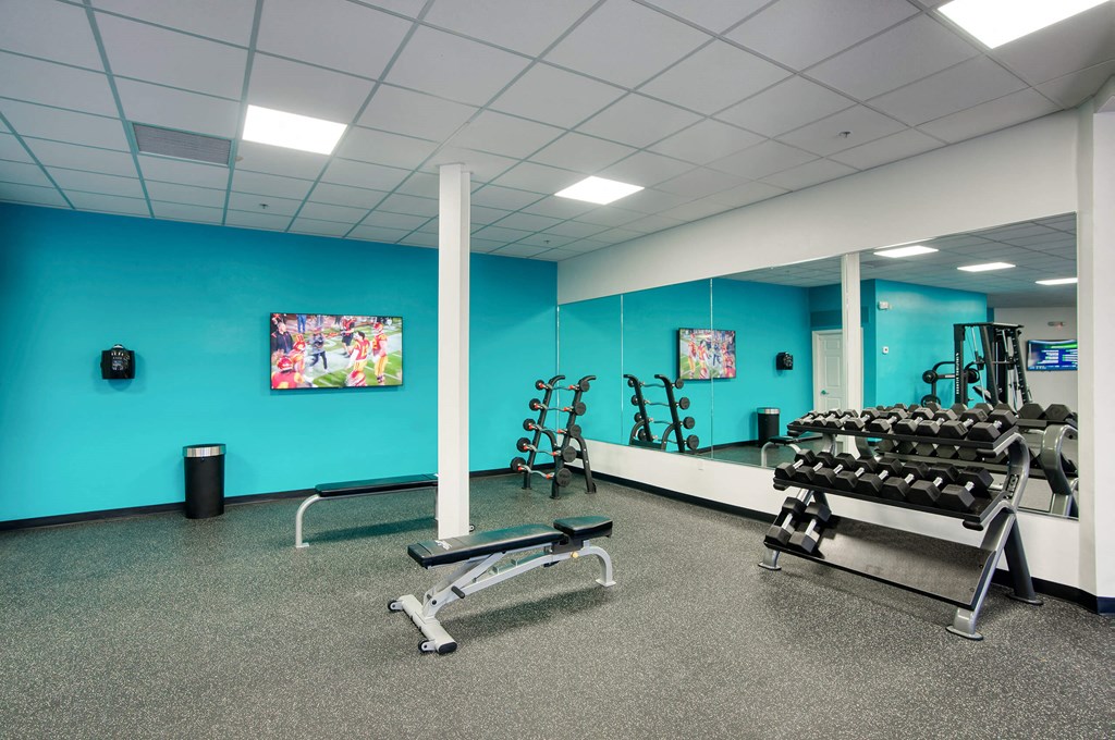 the gym is equipped with weights and cardio equipment at Presidio Palms Apartments, Tucson, Arizona