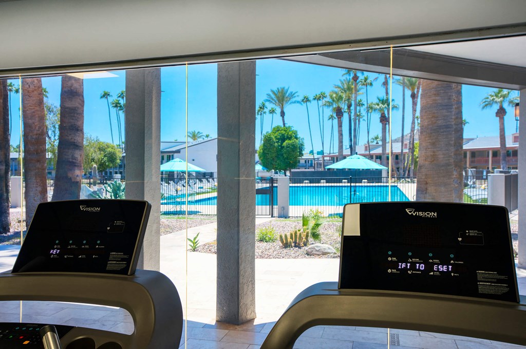 a view of a swimming pool from a treadmill in a hotel lobby at Presidio Palms Apartments, Tucson, AZ, 85701