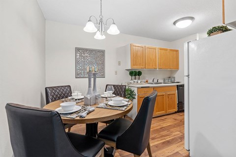 dining table and kitchen with wood cabinets