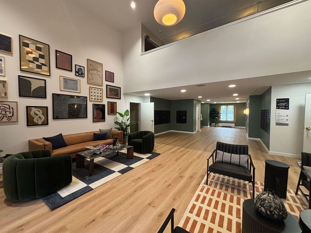 A living room with a black chair and a coffee table.