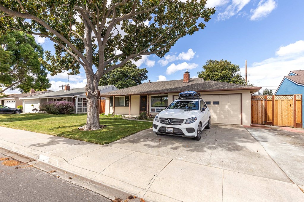 a car parked in a driveway in front of a house