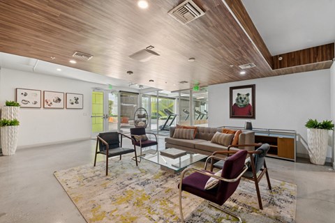 A living room with a glass table and chairs.