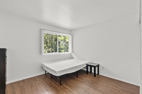 A bedroom with bed and night stand