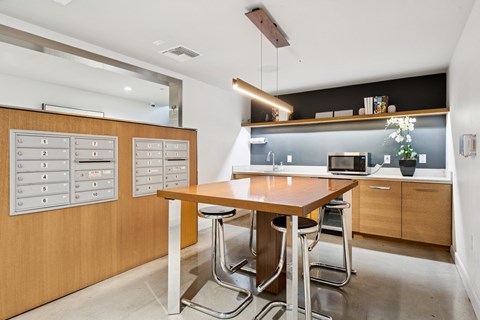 A modern kitchen with a wooden table and stainless steel chairs.