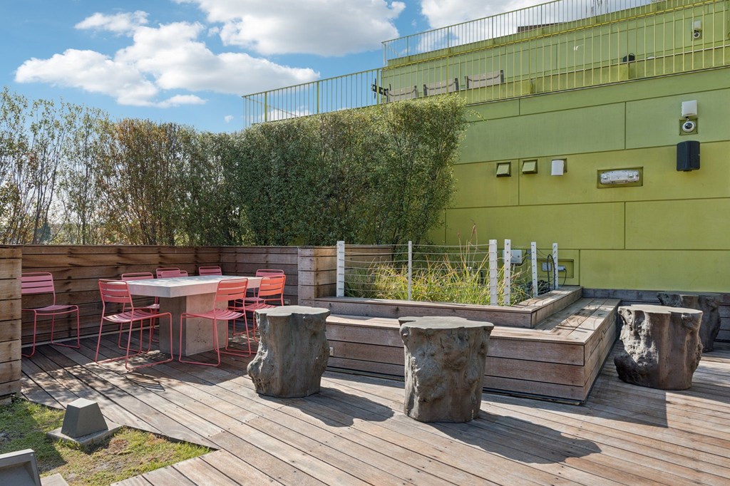 A wooden deck with a table and chairs.