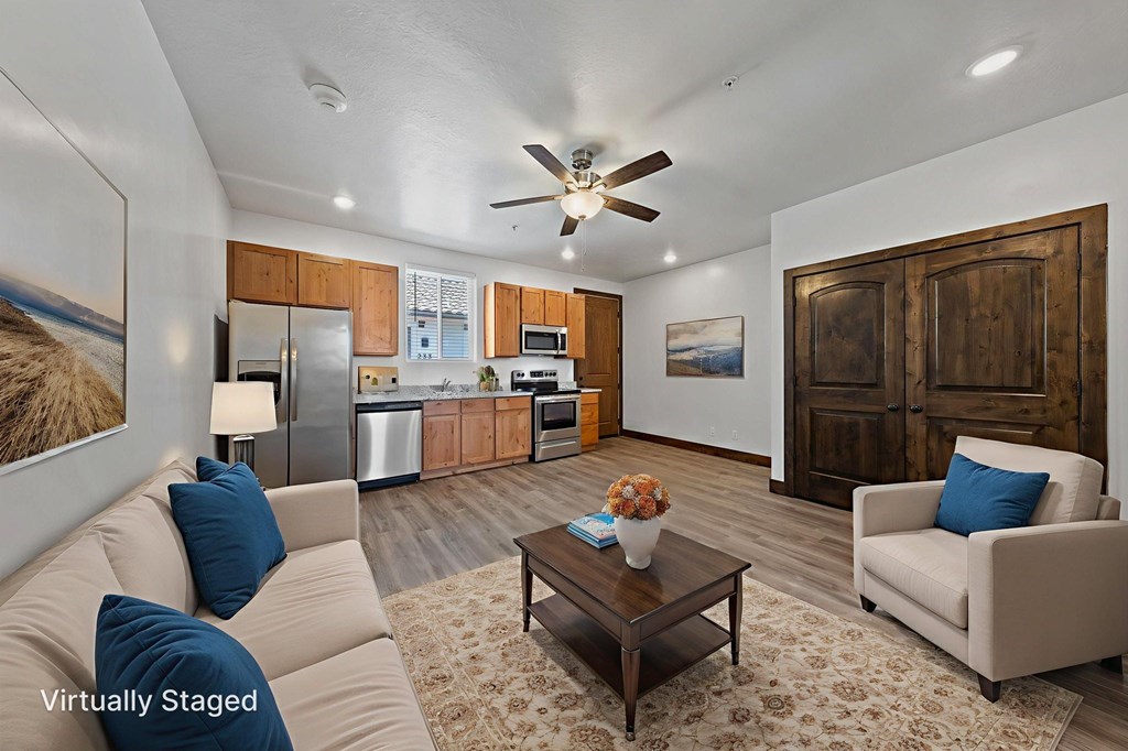 A living room with a couch, a chair, a coffee table, and a painting on the wall.