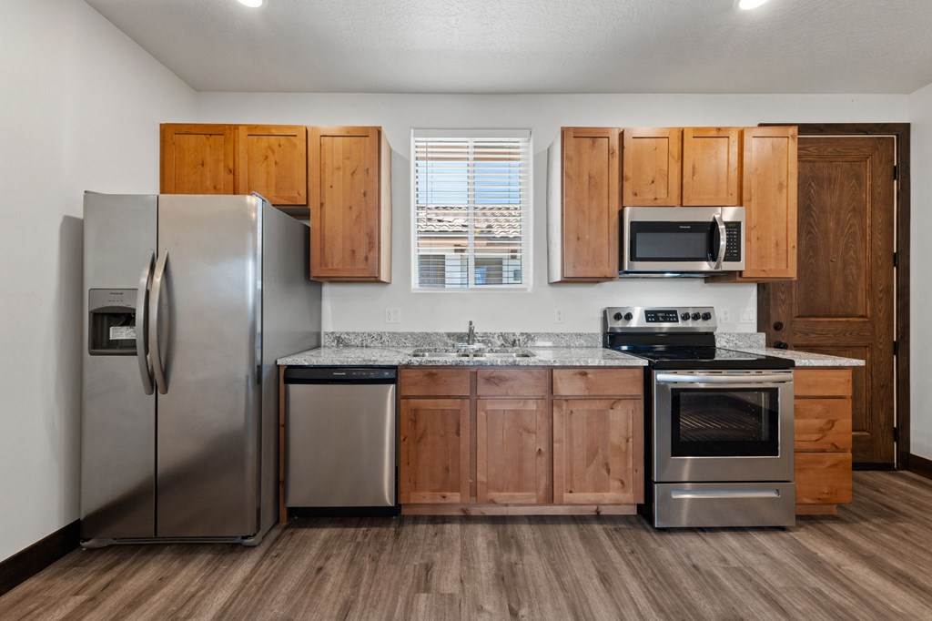A kitchen with wooden cabinets and stainless steel appliances.