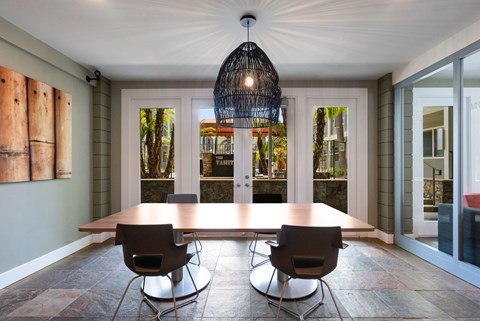 A dining room with a wooden table and chairs.