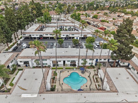 A swimming pool in the middle of a courtyard surrounded by buildings.