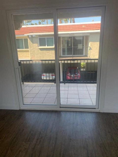 a sliding glass door in a living room looking out onto a balcony