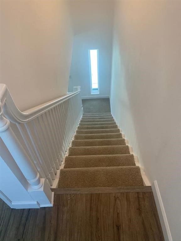 a staircase with a window at the top of the stairs