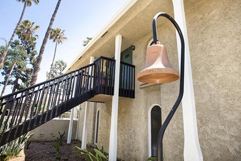 a bell hanging from the side of a building