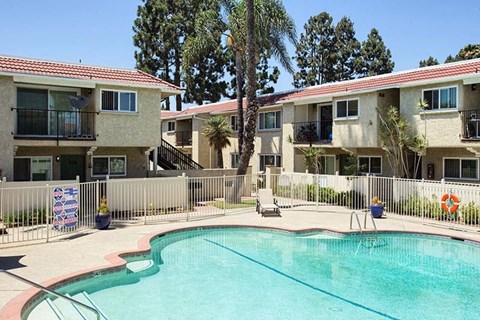 a swimming pool in front of an apartment building