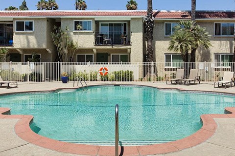 a large swimming pool in front of a building