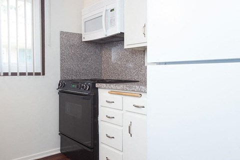 a small kitchen with a stove and a microwave