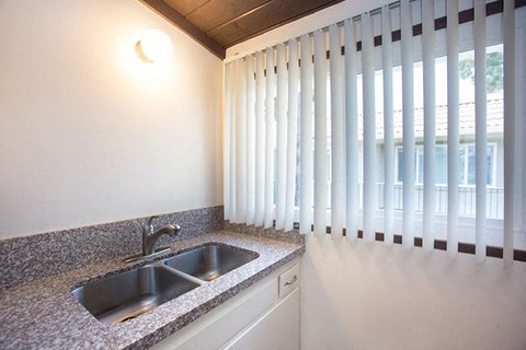 a kitchen with a sink and a window