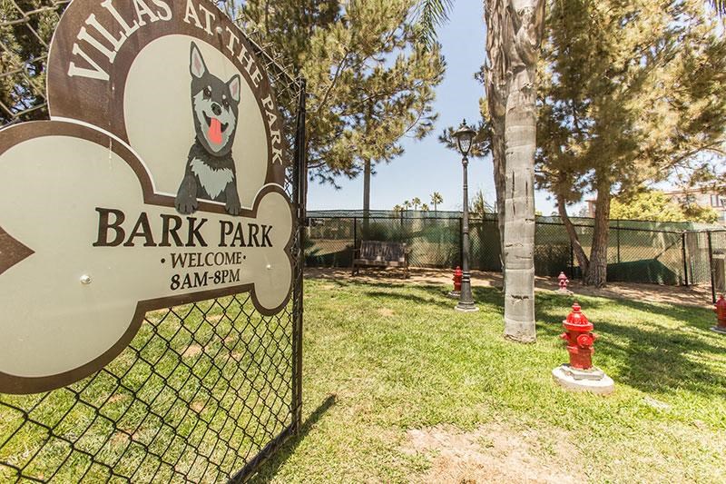 a sign for a bark park with a dog on it