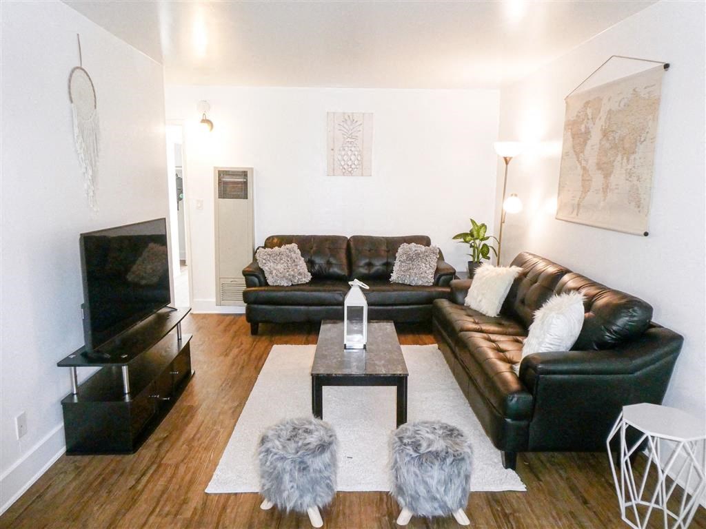 a living room with leather couches and a coffee table