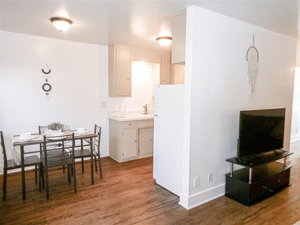 a kitchen and dining room with a table and a television