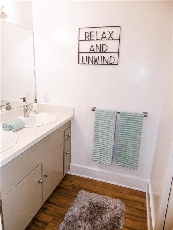 a bathroom with two towels and a sink and a mirror